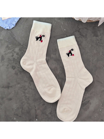 Side view of Rufia black cat crew socks highlighting ribbed cuff
