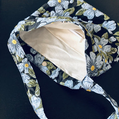 Cosbai Daisy Garden tote bag styled with casual outfit on a wooden surface