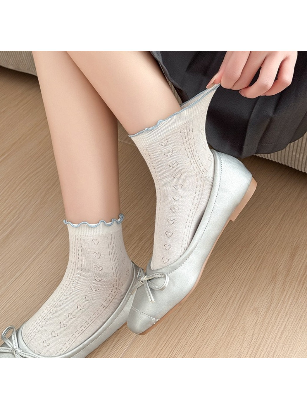 Close-up of Rufia crew socks showing red edge stitching on white fabric
