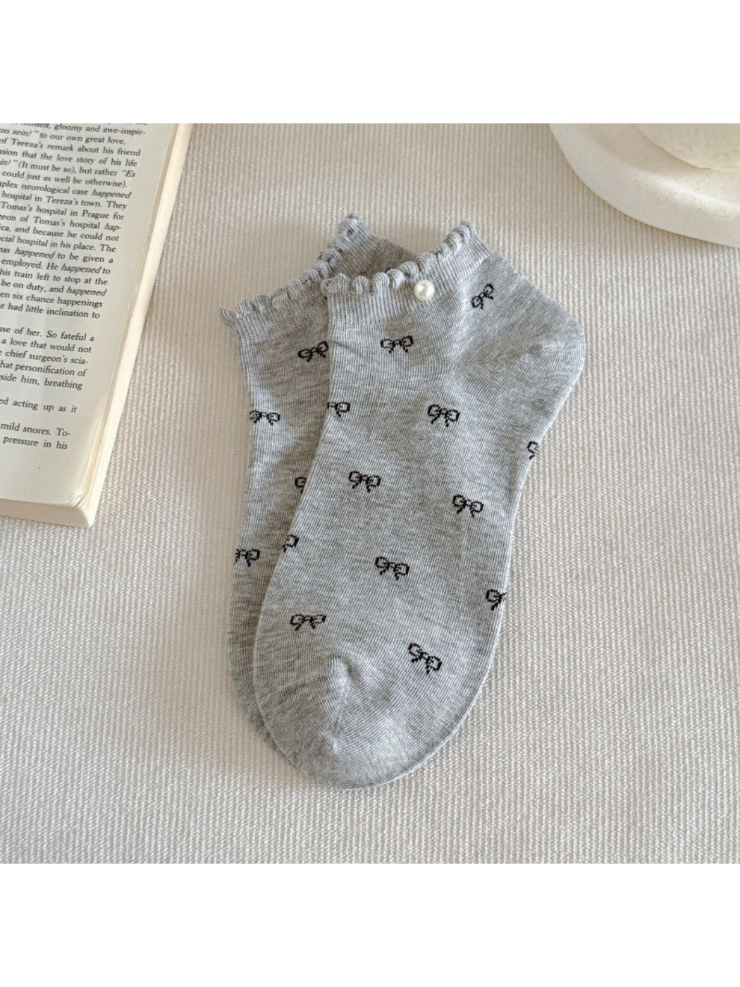 Rufia ankle socks styled with outfit, featuring pink bows and frill trim