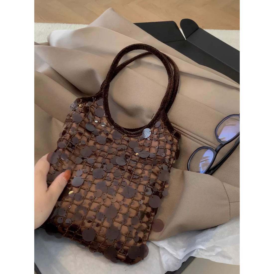 Close-up of the chocolate sequin texture and gold chain detail on the Cosbai mini handbag