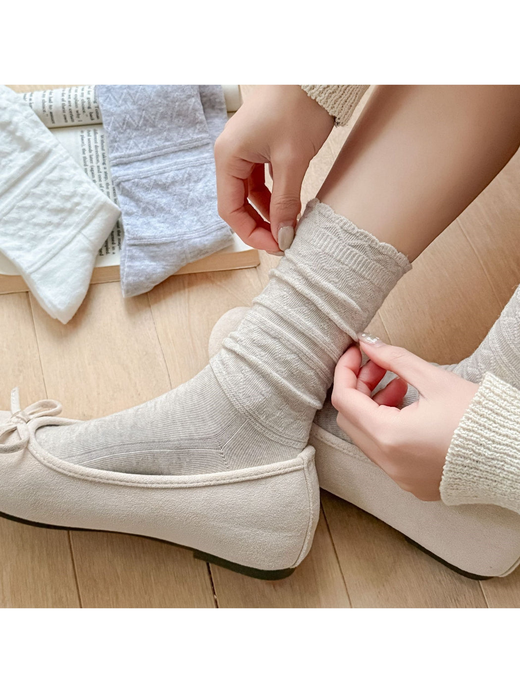 Pair of Rufia soft scallop knit socks worn on feet with scalloped trim visible