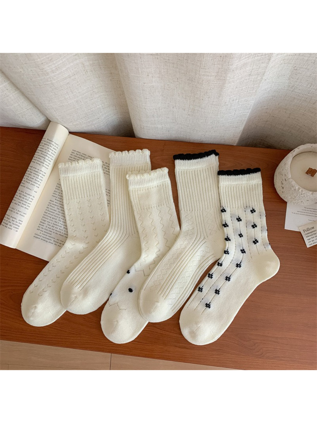 Rufia socks folded to display ribbed cuff and floral design on soft material