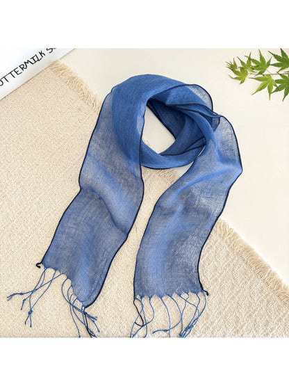 Sheer solid summer scarf in pastel shade shown with natural light emphasizing transparency