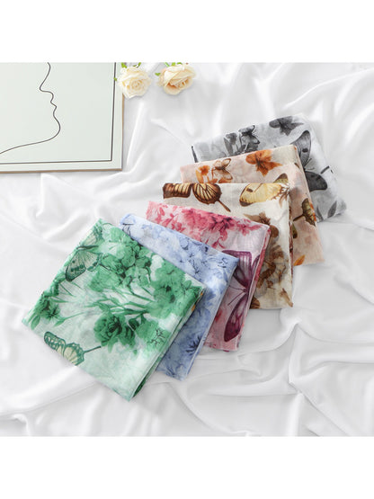Close-up of botanical butterfly print on lightweight scarf fabric