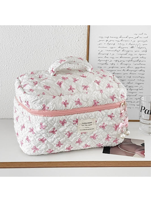 Cosbai travel makeup bag with pink bow print and zippered closure on white background