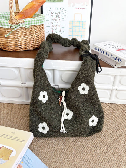 Cosbai floral knit bag displayed on wooden surface with lighting