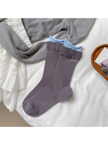 Model wearing Rufia soft ruffle ribbed crew socks with casual sneakers