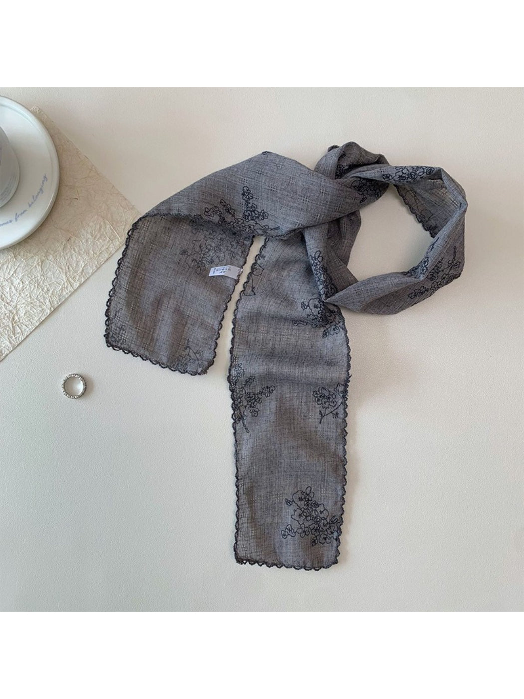 Scarvii narrow scarf styled with casual outfit highlighting floral stitch design
