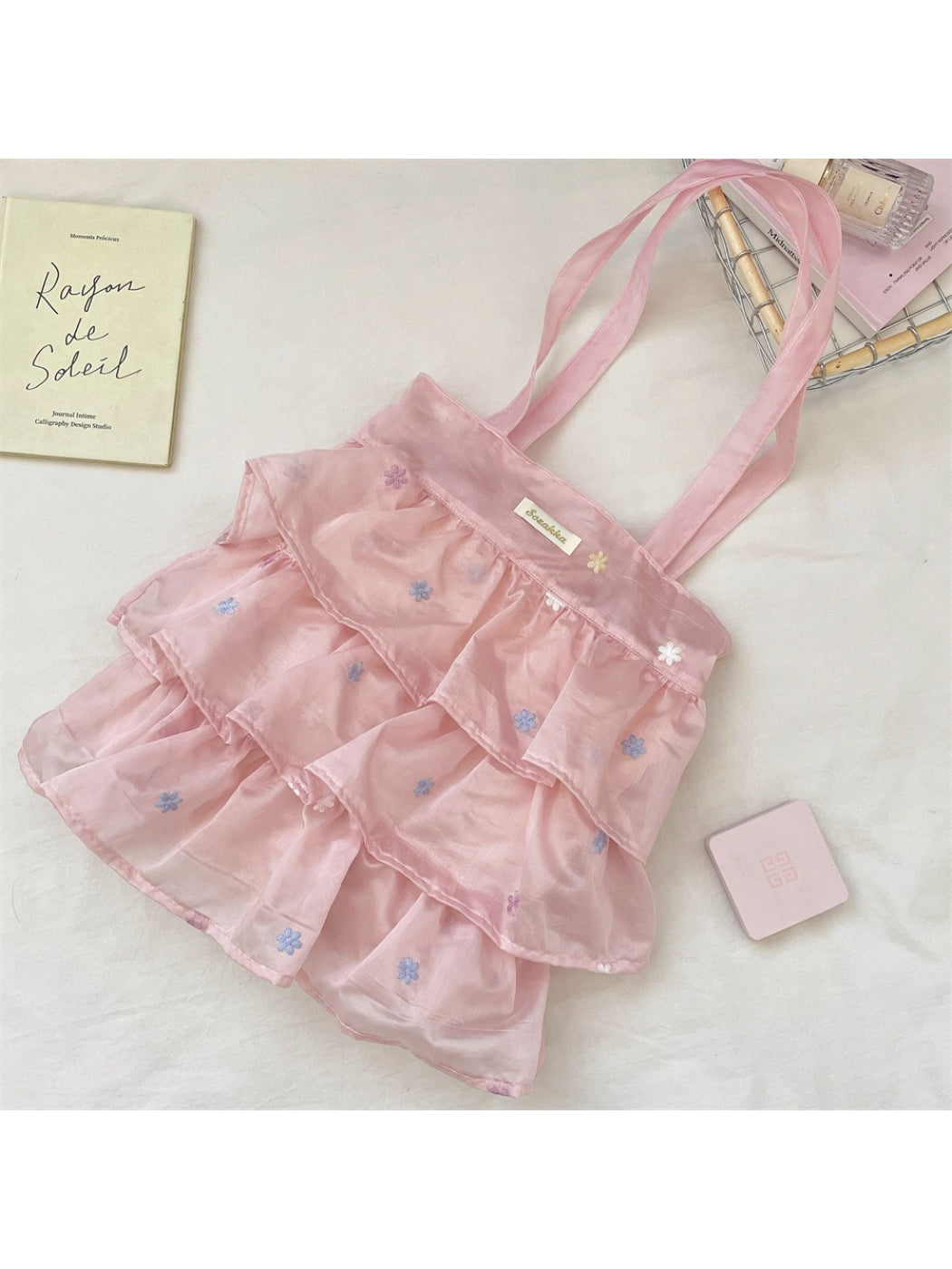 Side view of Cosbai pastel mesh ruffle tote bag showing depth and handle attachment