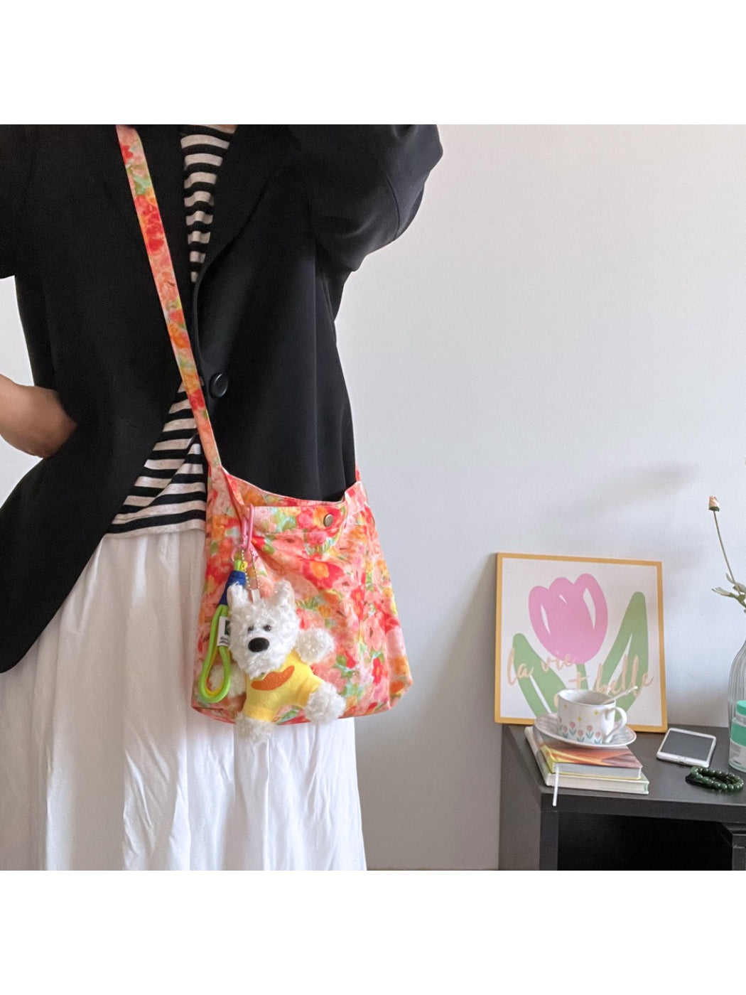 Cosbai Painterly Bloom shoulder bag with floral print and attached dog charm on white background