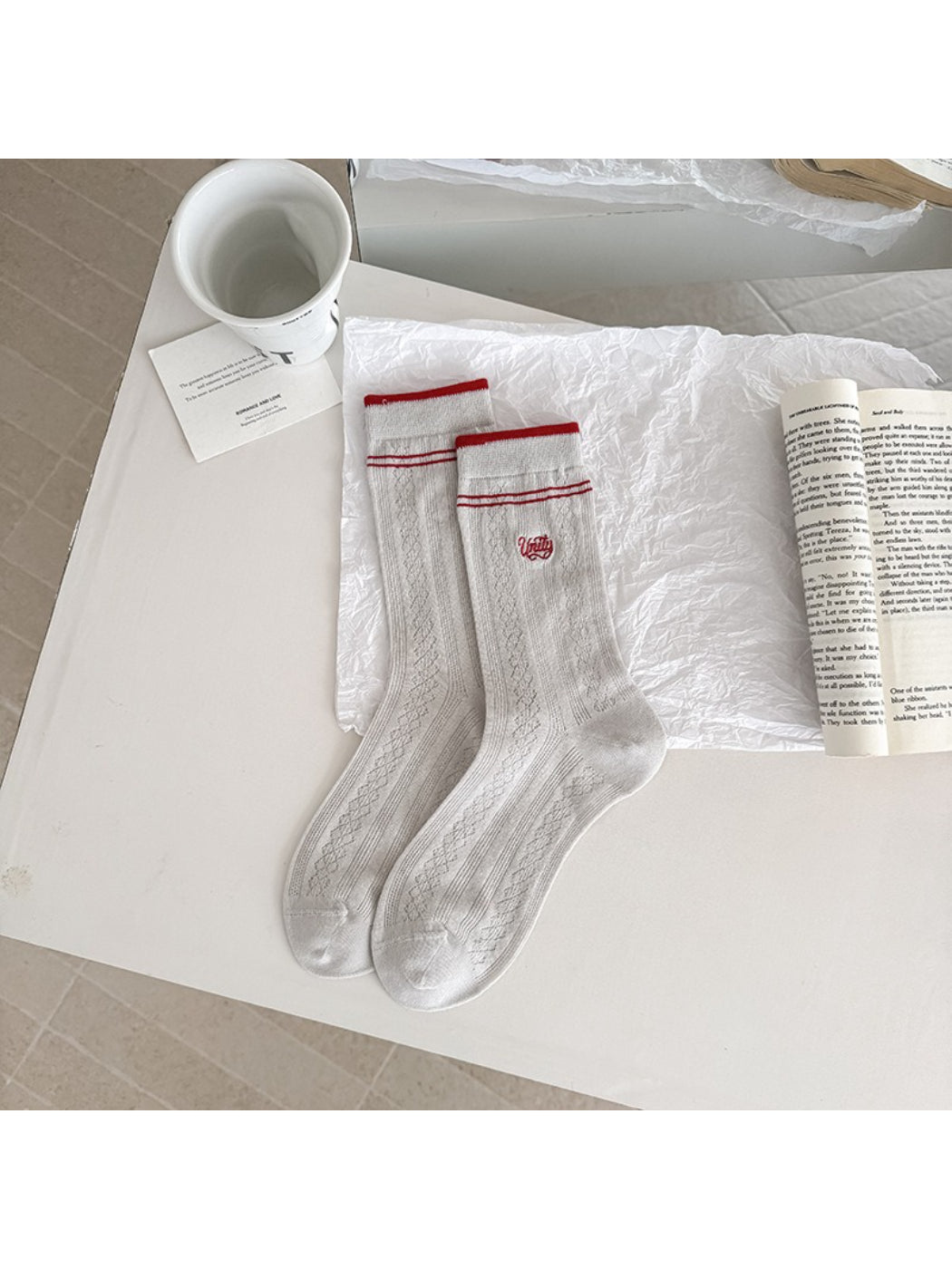 Rufia crew socks folded neatly with visible vintage stripe accents