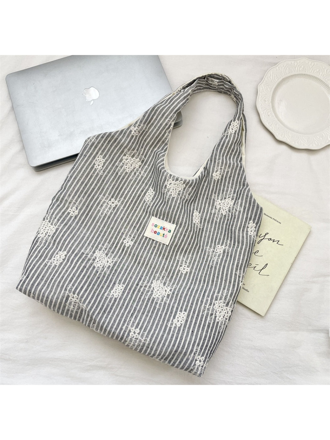 Close-up of Cosbai tote bag fabric texture and soft stripe design