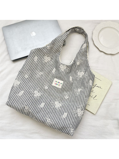 Close-up of Cosbai tote bag fabric texture and soft stripe design