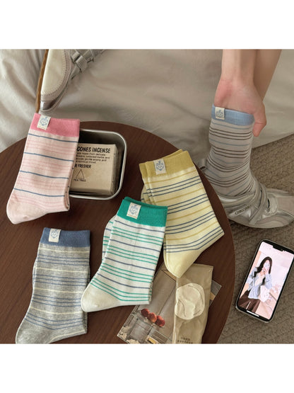 Pair of Rufia soft stripe patch socks in beige and white with ribbed cuffs