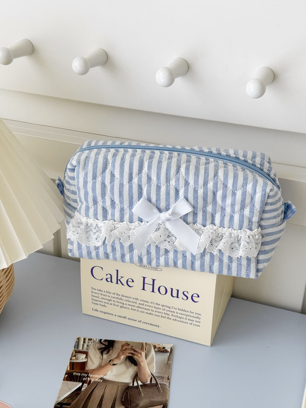 Side view of Cosbai lace trim stripe cosmetic pouch highlighting texture