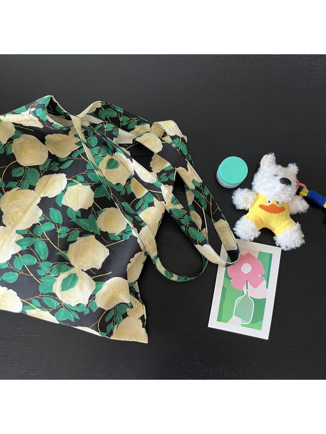 Close-up of dog charm attached to vintage rose wrap shoulder bag