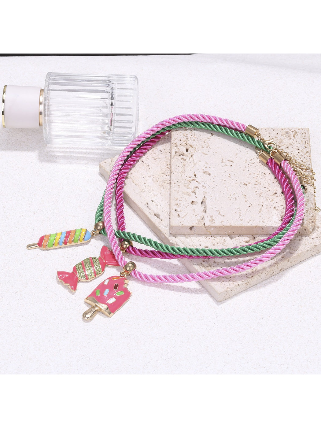 Close-up of Neckit color rope necklace featuring candy charms in various bright colors