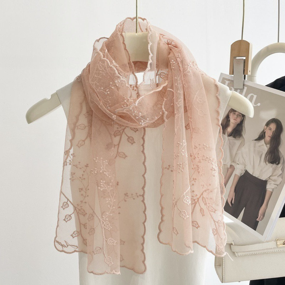 Folded sheer scarf showcasing intricate embroidery details