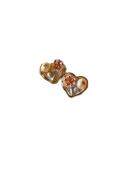 Earwish Romantic Floral Heart Earrings worn on a model's ears with matching floral outfit