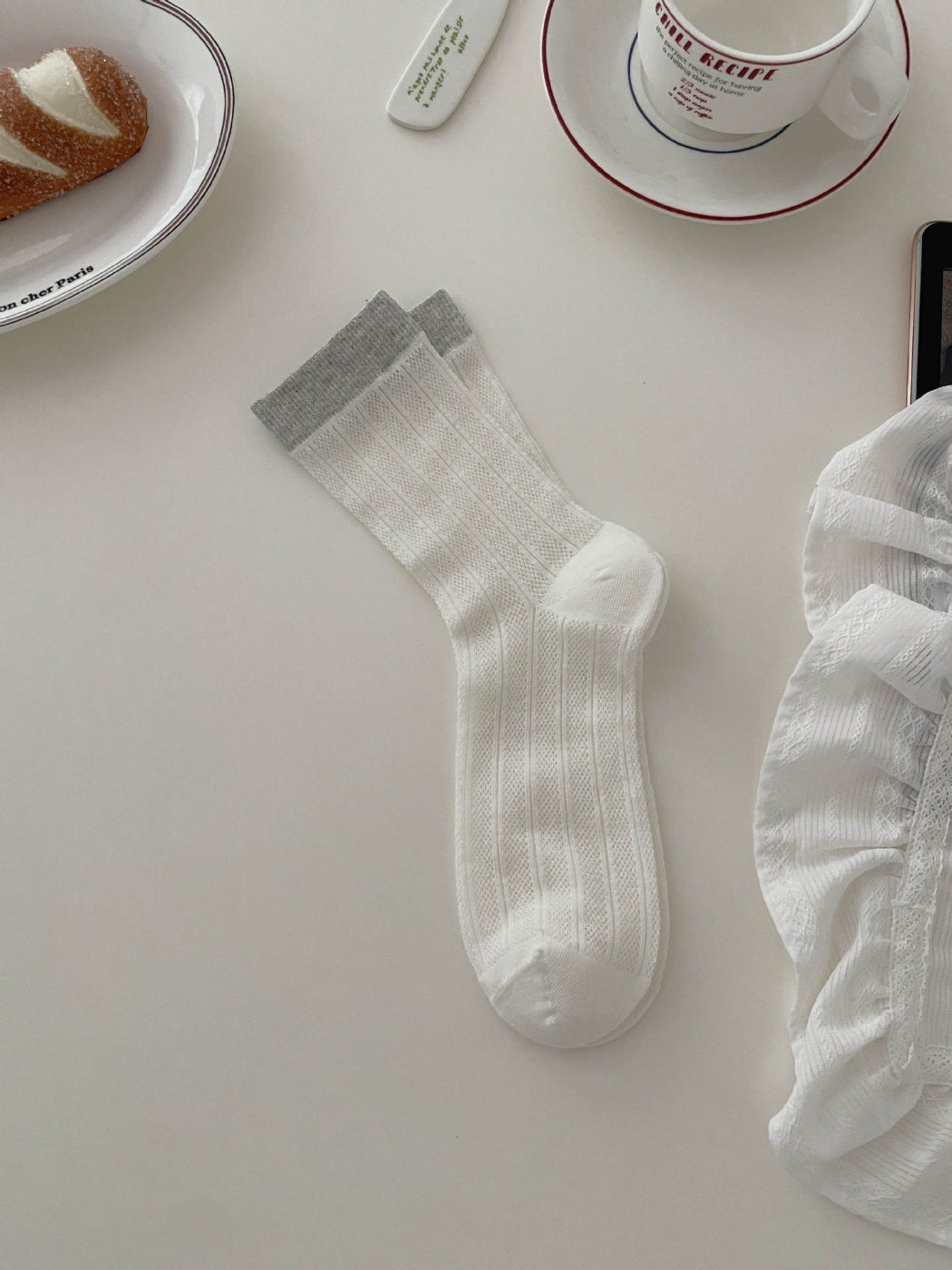 Side view of Rufia ribbed socks highlighting soft tone contrast pattern