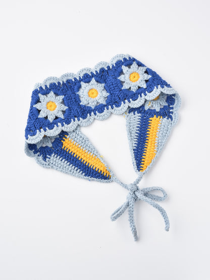 Detailed shot of crochet flower hairband showing texture and yarn quality