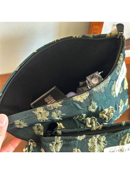 Cosbai elegant floral makeup pouch next to cosmetic brushes