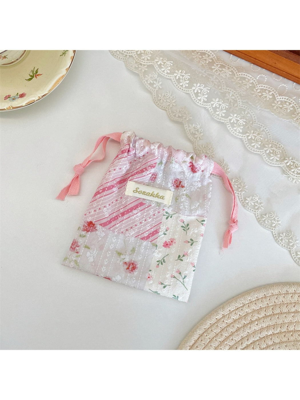 Side view of Cosbai drawstring pouch showing patchwork details and fabric texture