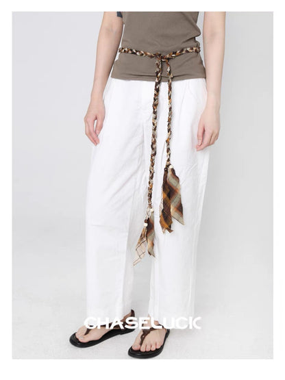 Beco braided fabric belt with tassel ends arranged in a circular shape