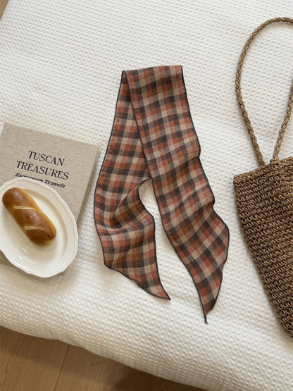 Classic plaid slim skinny scarf draped over a chair showcasing its pattern