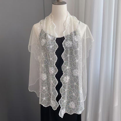 Folded floral lace scarf with delicate pearl trim on a white background