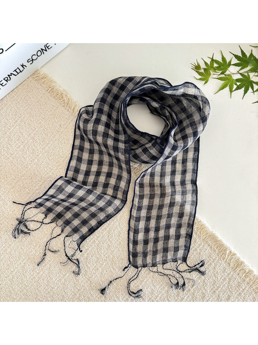 Folded soft check pattern long skinny scarf showing neat edges and pattern detail