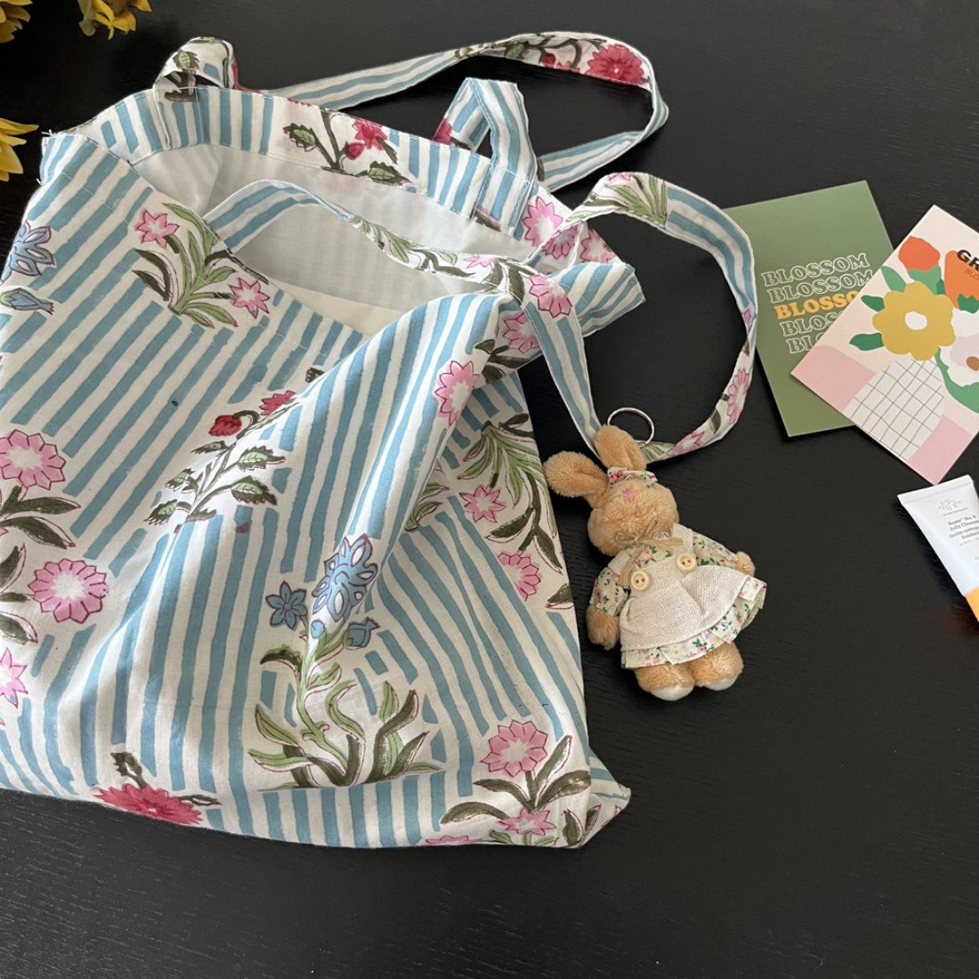 Close-up of blue and white striped floral pattern on tote bag fabric