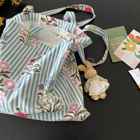 Close-up of blue and white striped floral pattern on tote bag fabric