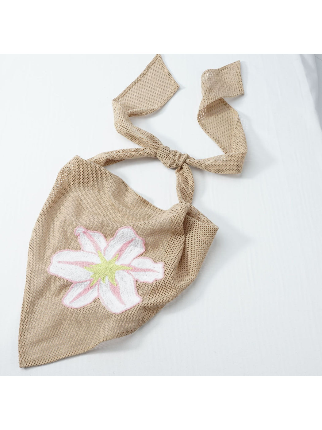 Scarvii bandana scarf styled around neck with floral embroidery visible