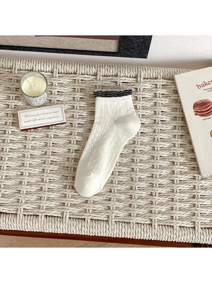 Rufia fine pointelle socks paired with casual outfit in soft light setting
