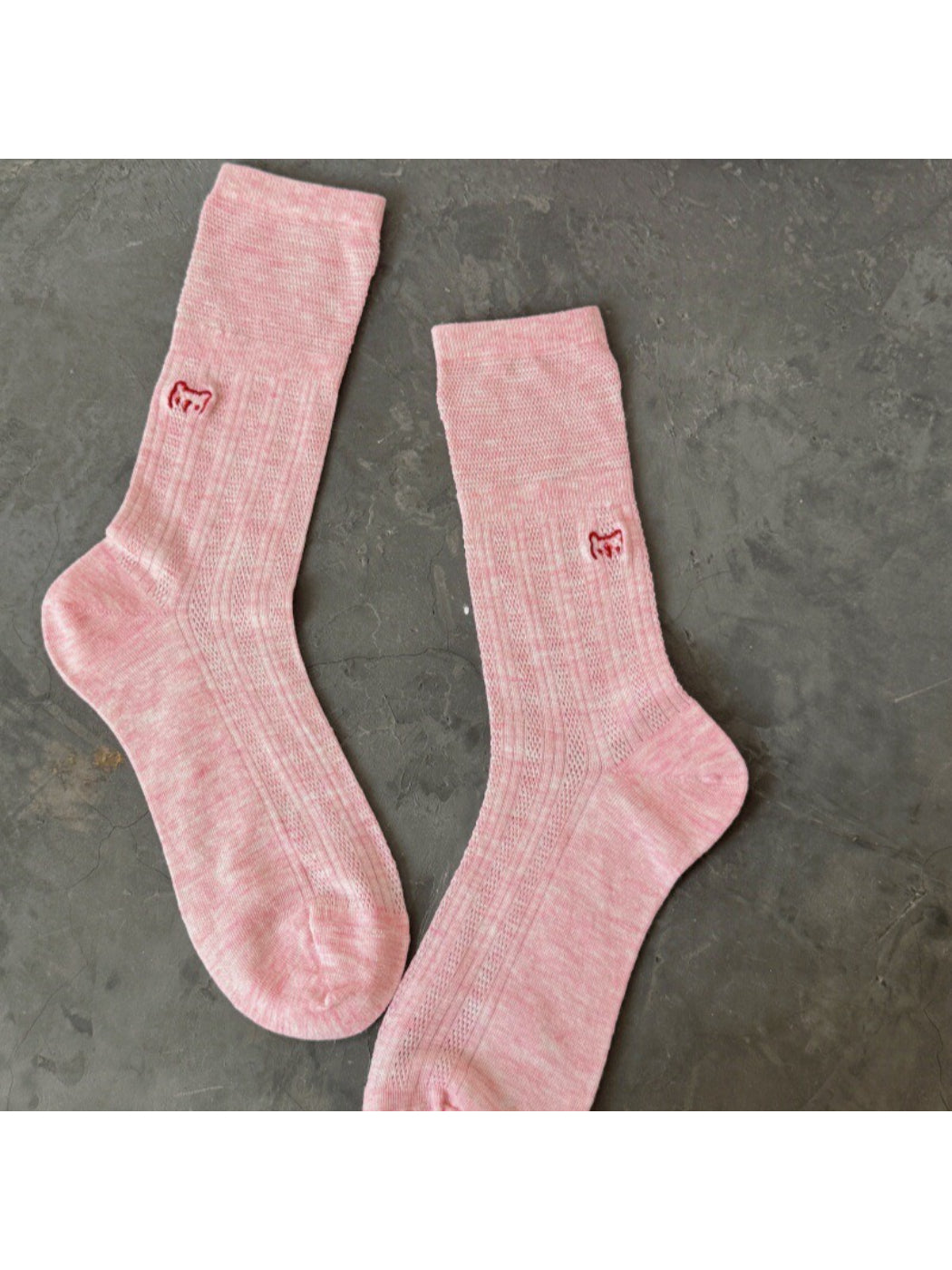 Rufia slouch socks displayed flat showing embroidered cat design