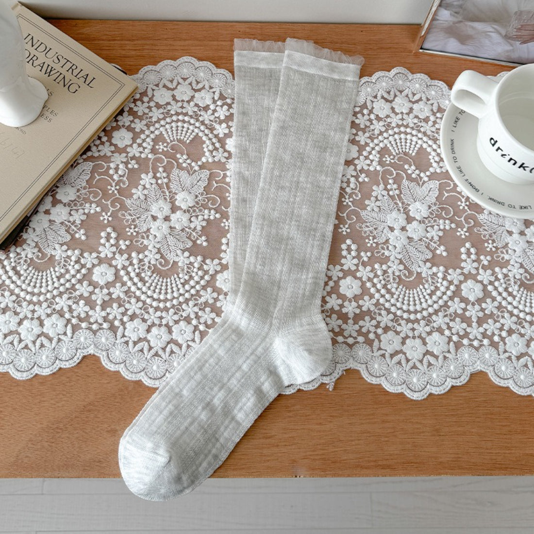 Model wearing Rufia beige ribbed crew socks with rolled-up pants