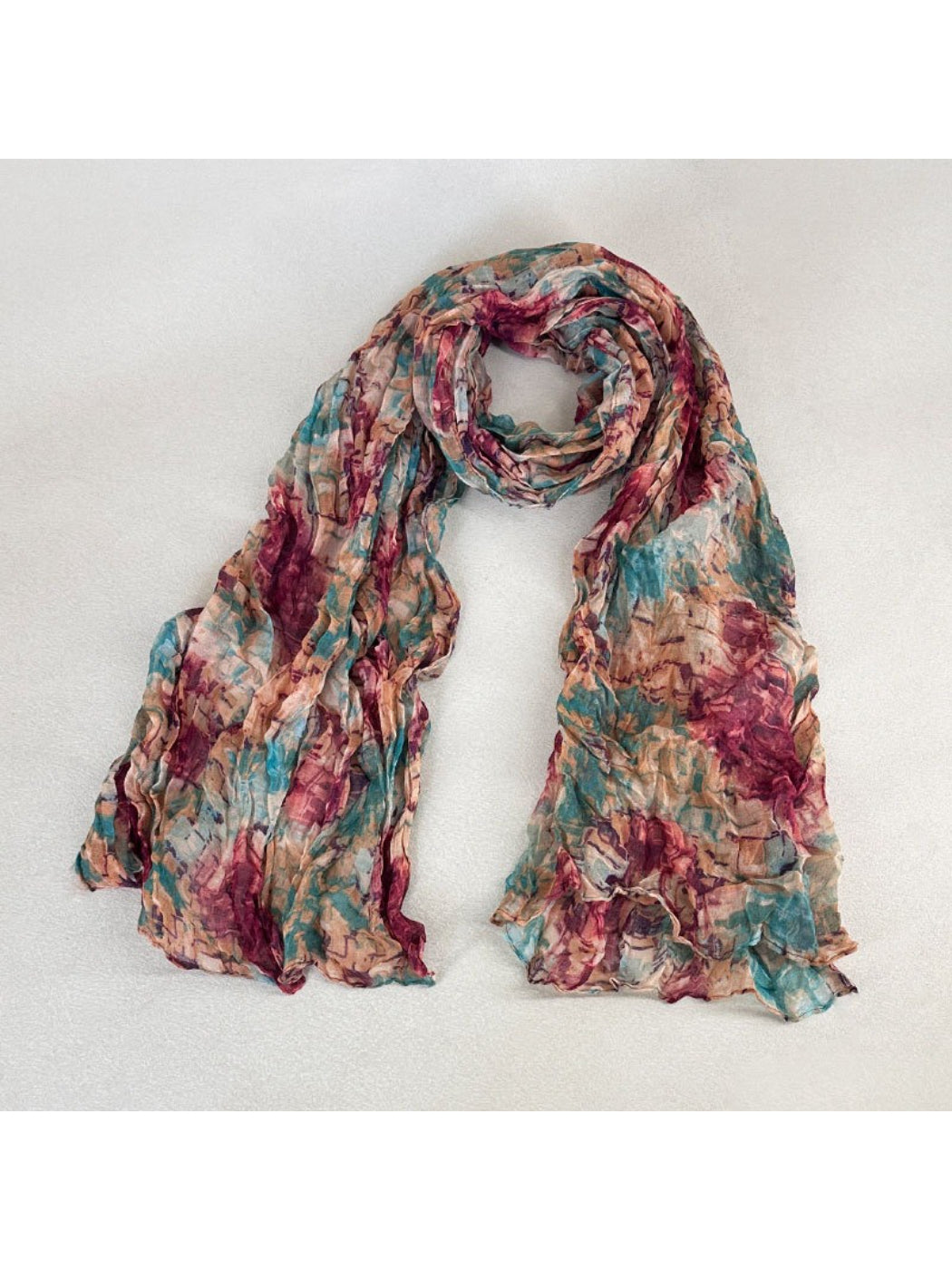Scarvii scarf folded neatly with visible brushstroke-inspired print in muted tones