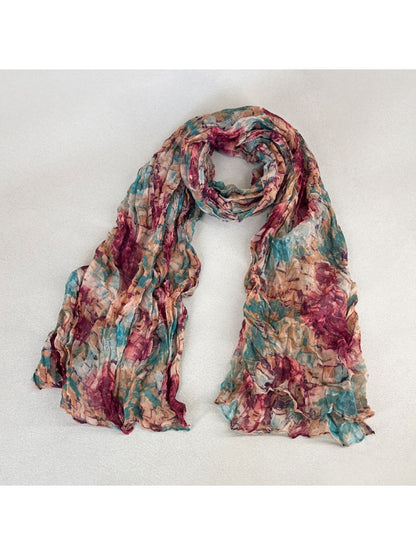 Scarvii scarf folded neatly with visible brushstroke-inspired print in muted tones