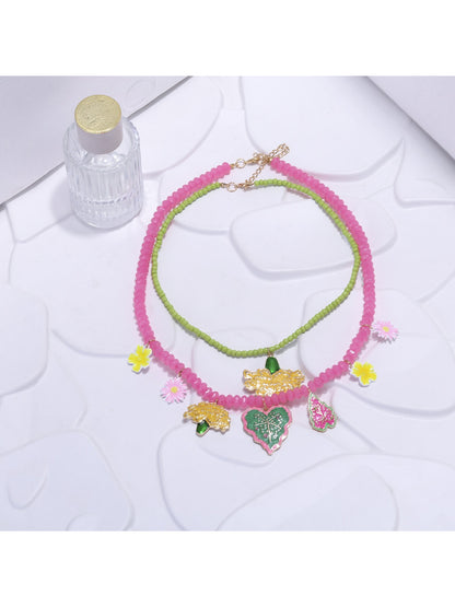 Close-up of Neckit Summer Fruit Necklace featuring colorful fruit and floral charm details