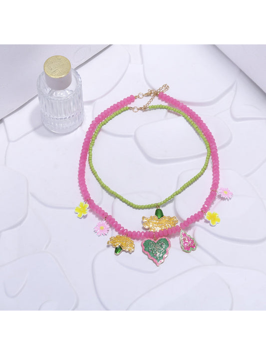 Close-up of Neckit Summer Fruit Necklace featuring colorful fruit and floral charm details