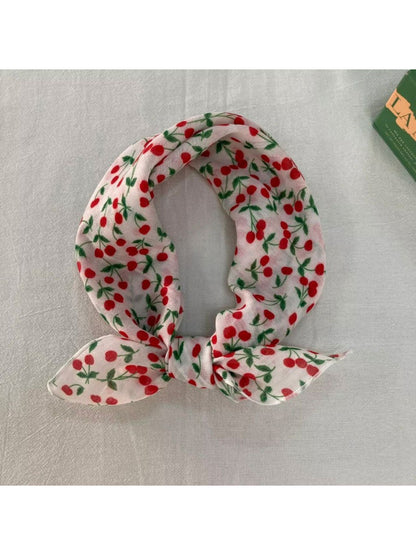 Flat lay of the garden print scarf showing vibrant floral motifs and soft fabric
