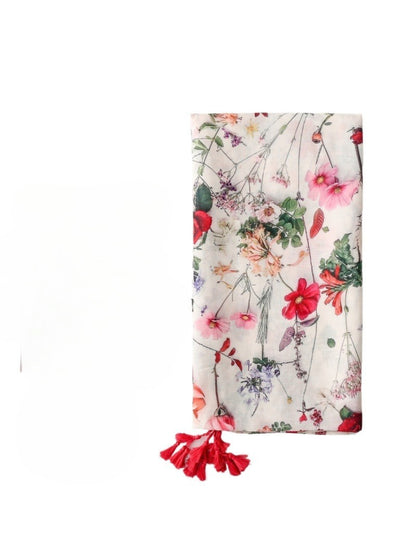 Close-up of Romantic Bloom Tassel Scarf fabric with detailed floral print and tassels