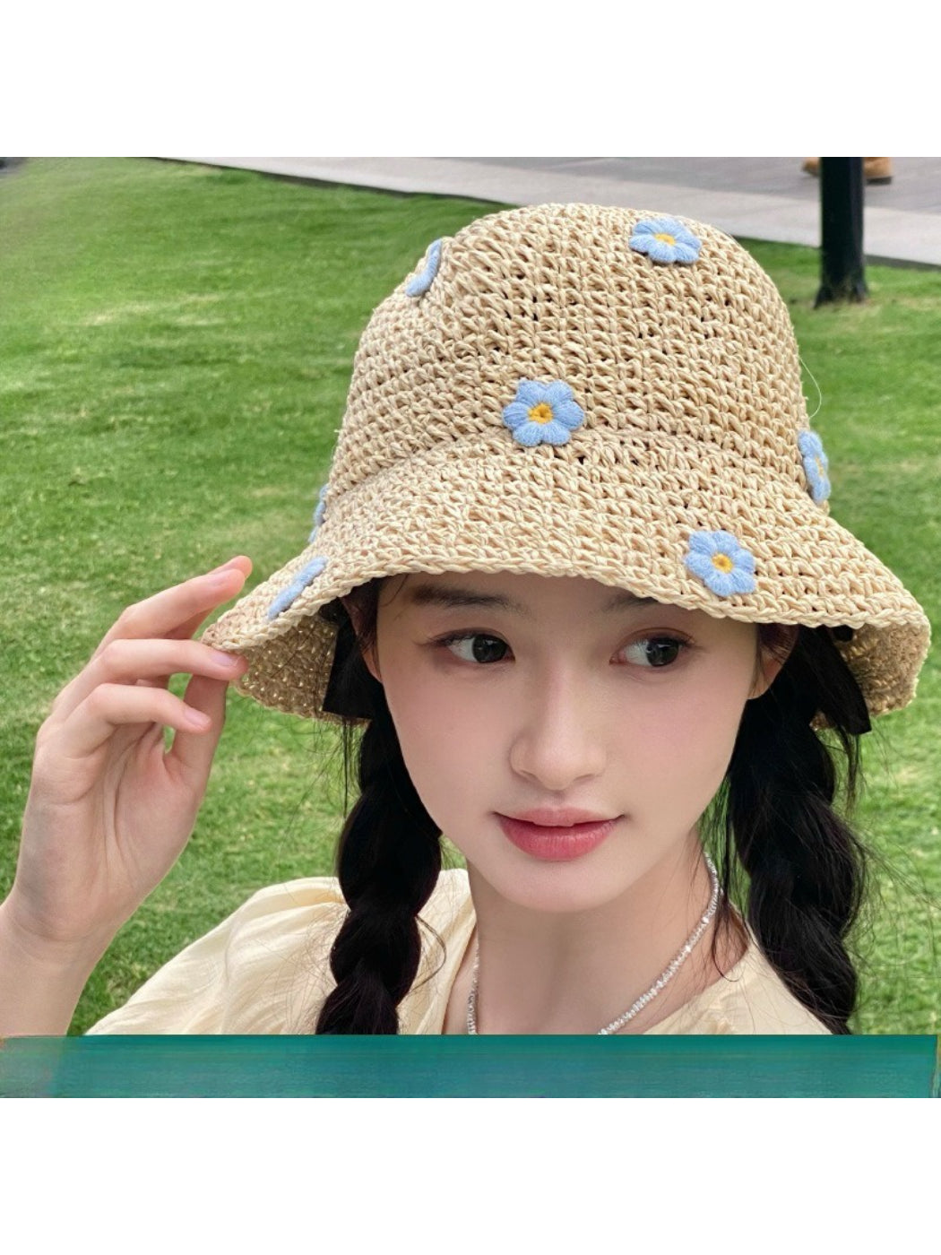 Haila woven sun hat displayed on a mannequin with scattered daisy print