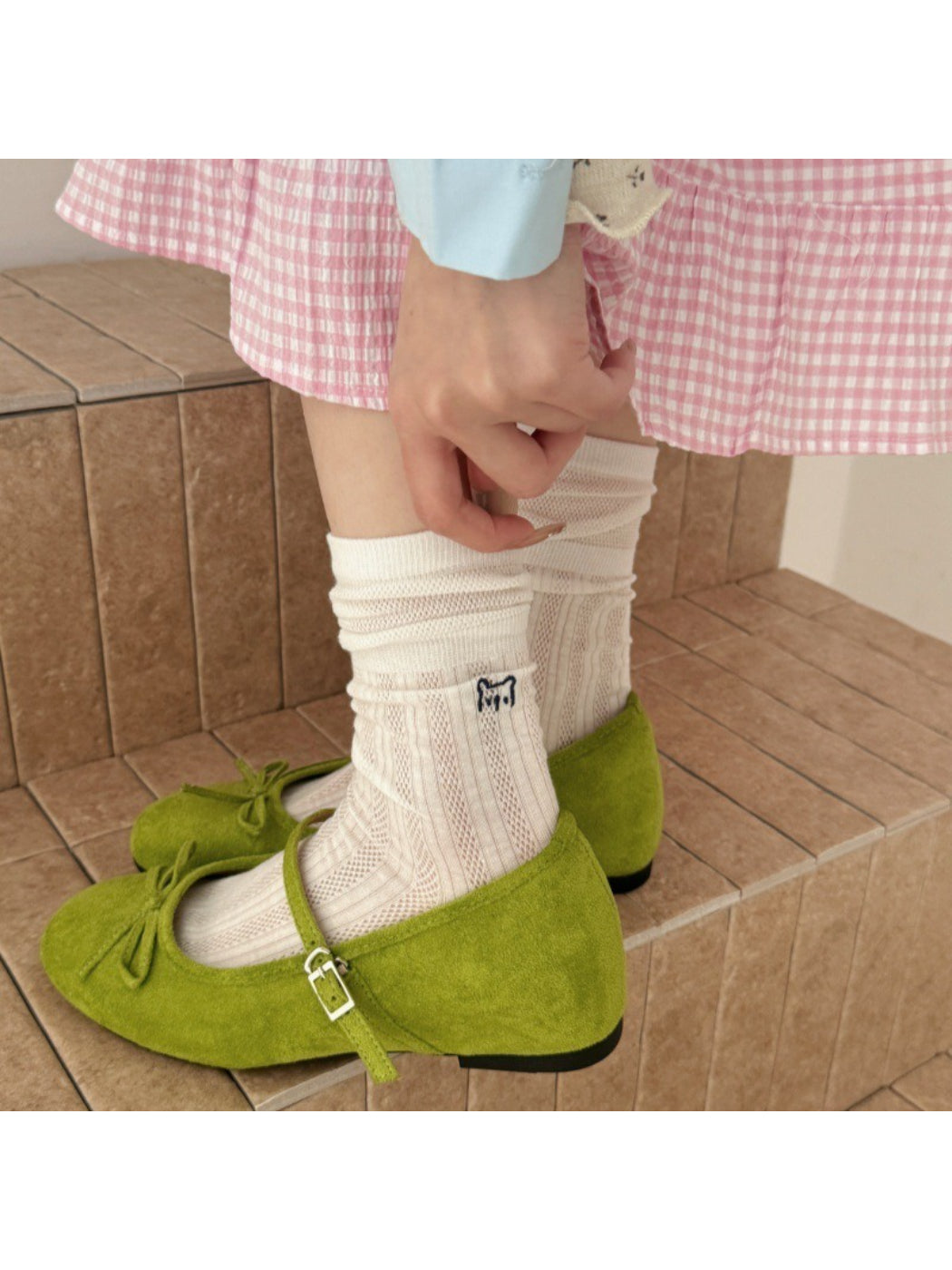 Pair of Rufia slouch socks with black cat embroidery on white fabric