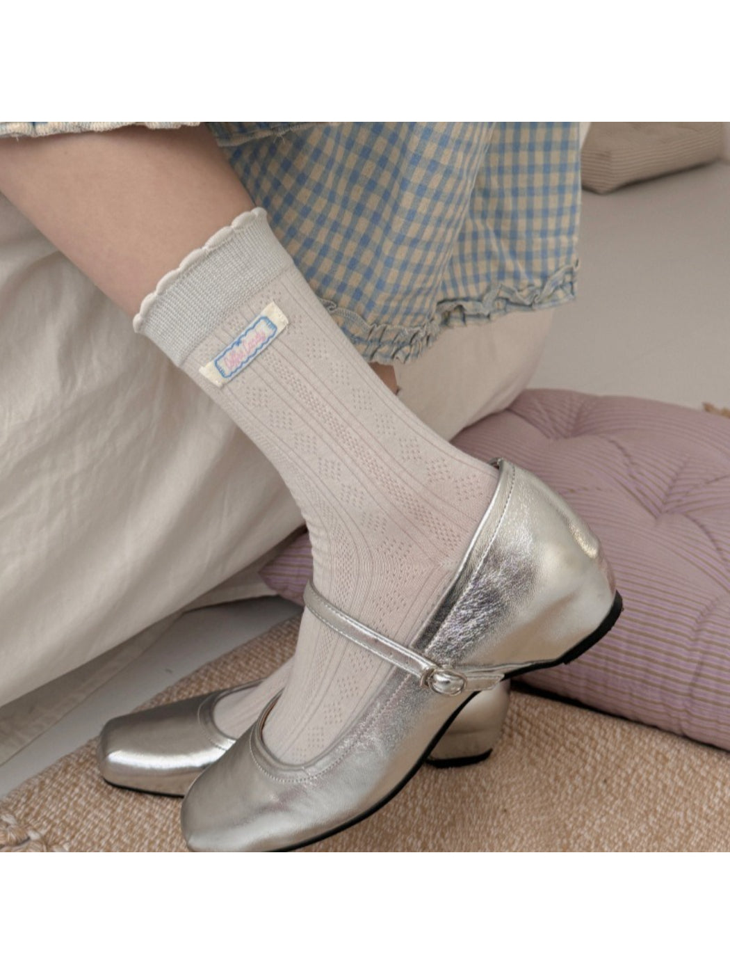 Pair of Rufia soft scallop trim socks in light beige color displayed flat