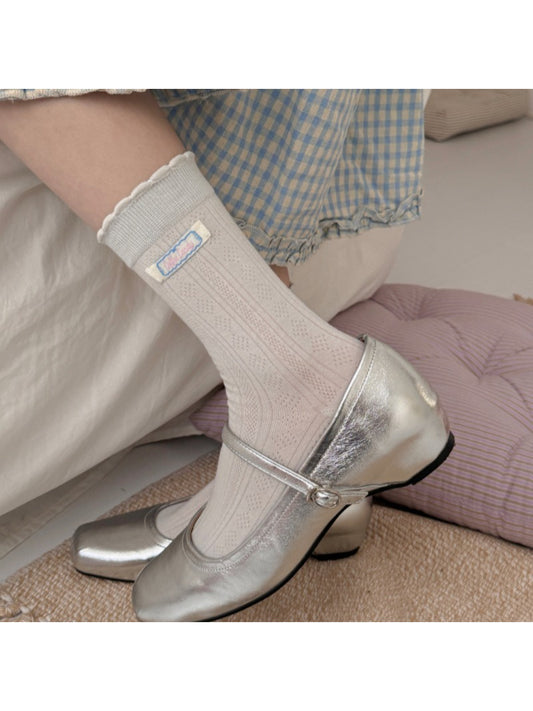 Pair of Rufia soft scallop trim socks in light beige color displayed flat