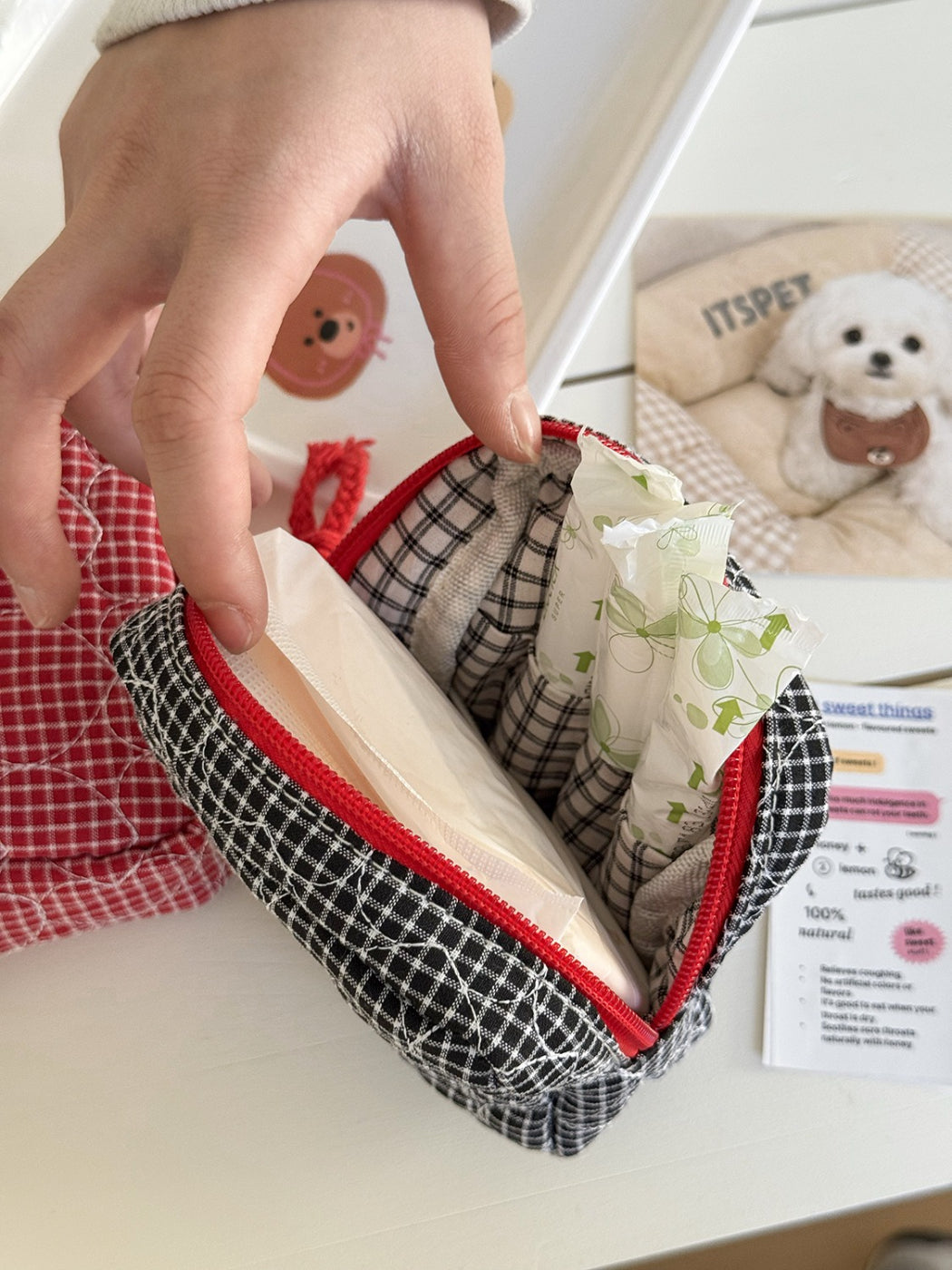 Cosbai travel pouch placed on wooden surface with travel accessories