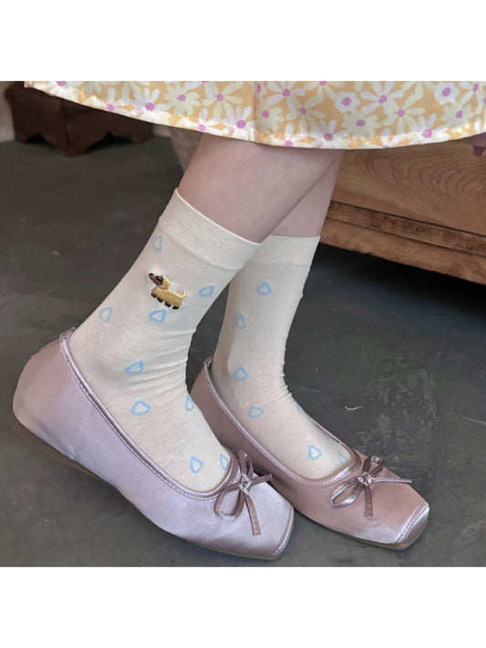 Close-up of blue raindrop and dog pattern on white Rufia Everyday Socks